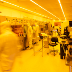 Students wearing cleanroom garments while working in the UW Washington Nanofabrication Facility.