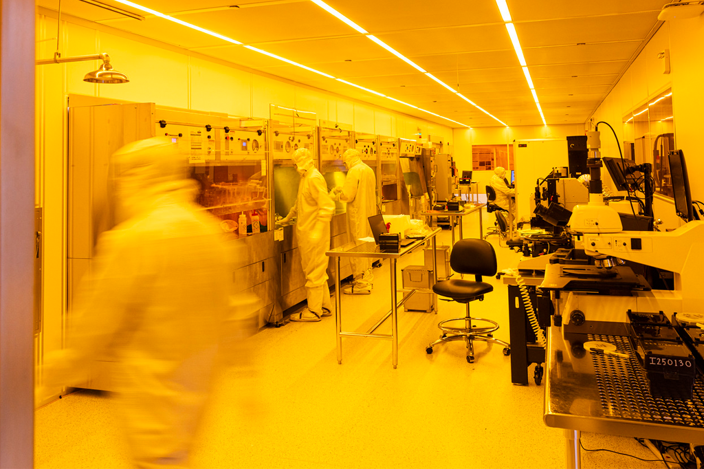 Students wearing cleanroom garments while working in the UW Washington Nanofabrication Facility.